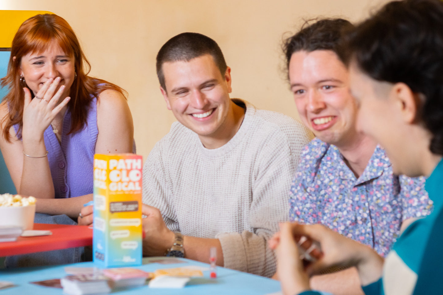 Friends and Family Playing Pathological Party Trivia Card Board Game Laughing