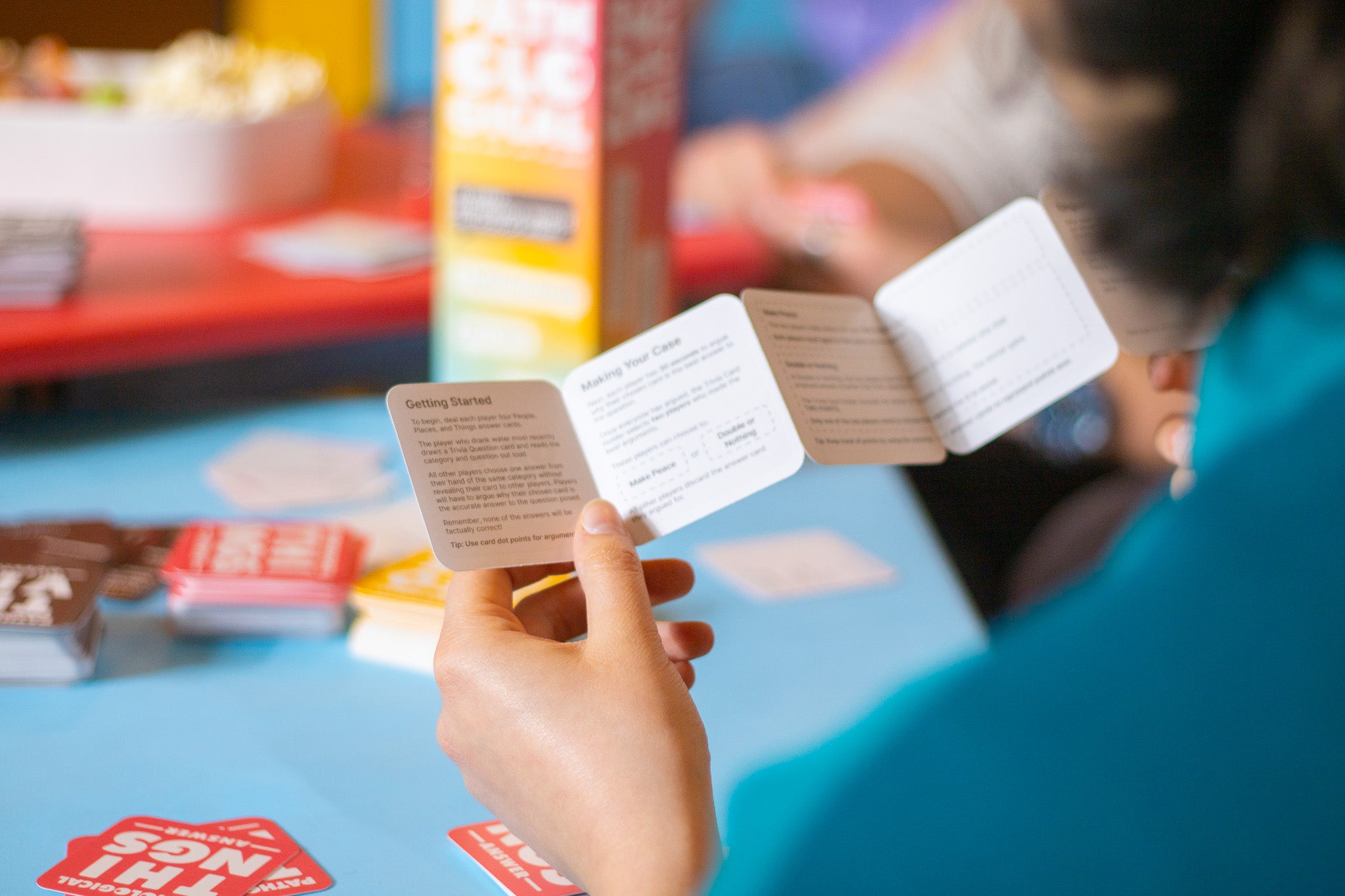 Player Reading Rules of Pathological Party Card Board Game